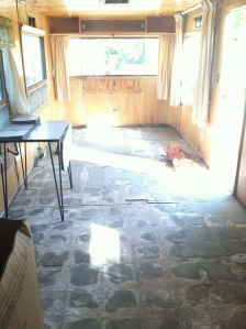 The bare floor!! This shows the living room and most of the kitchen floor with the killer tiles GONE!
